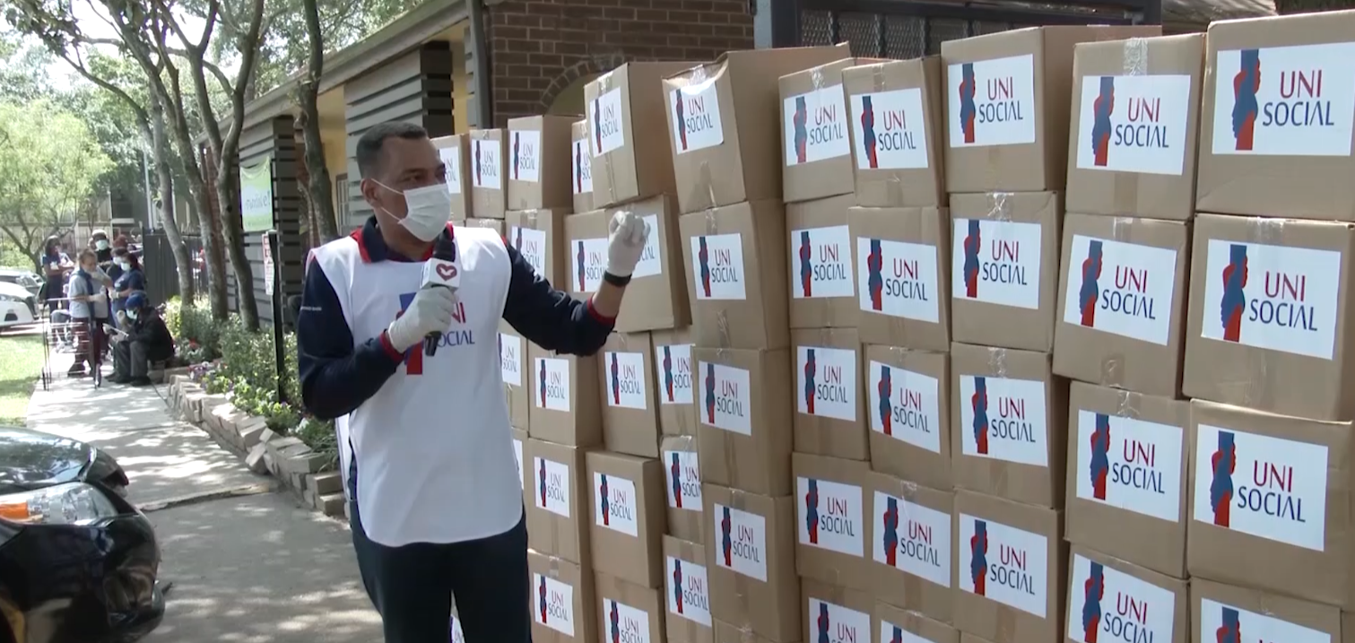 Bishop Joshua near many boxes of food prior to the distribution in a local community