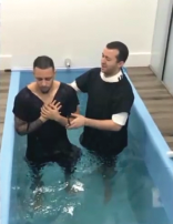 Dyandro being baptized in water