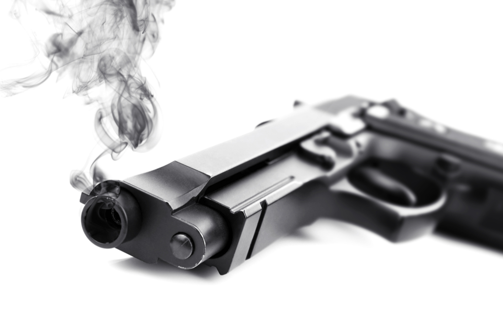 a gun laying down with smoke coming out of its mouth